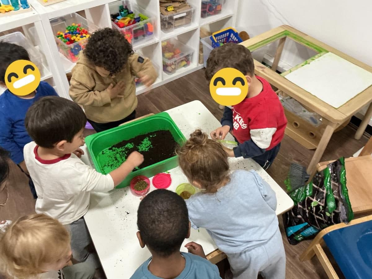blossoming minds daycare children exploring sensory play activity together