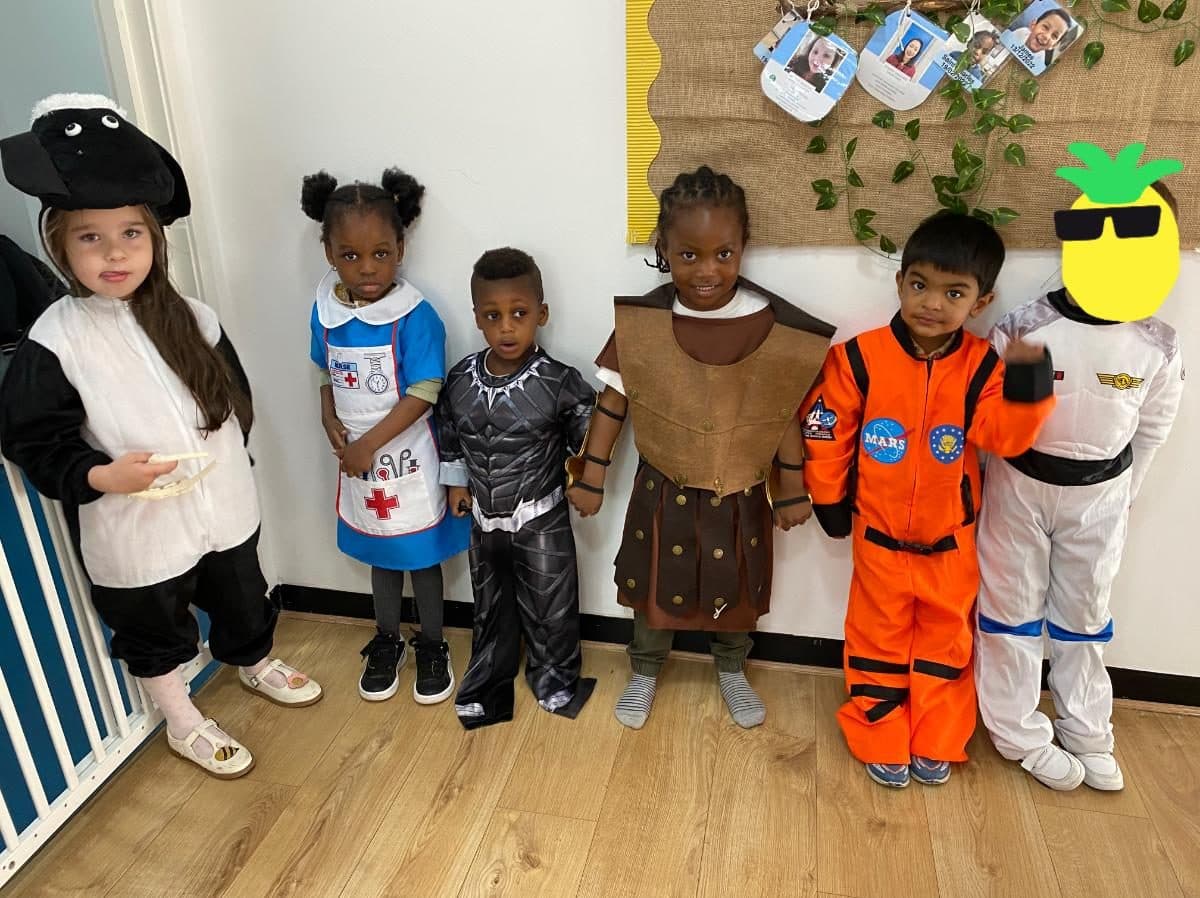 blossoming minds daycare children in colorful costumes together