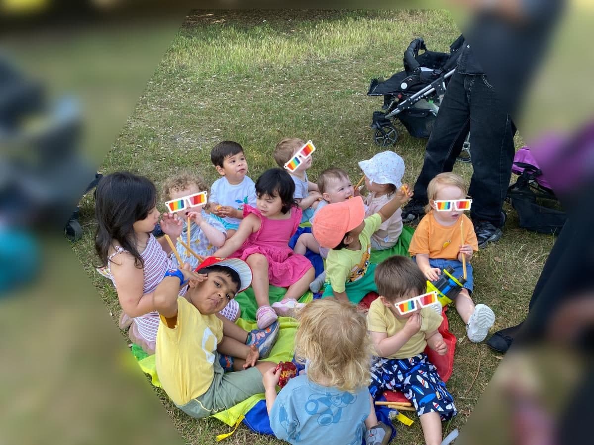 blossoming minds daycare children sitting outdoors together