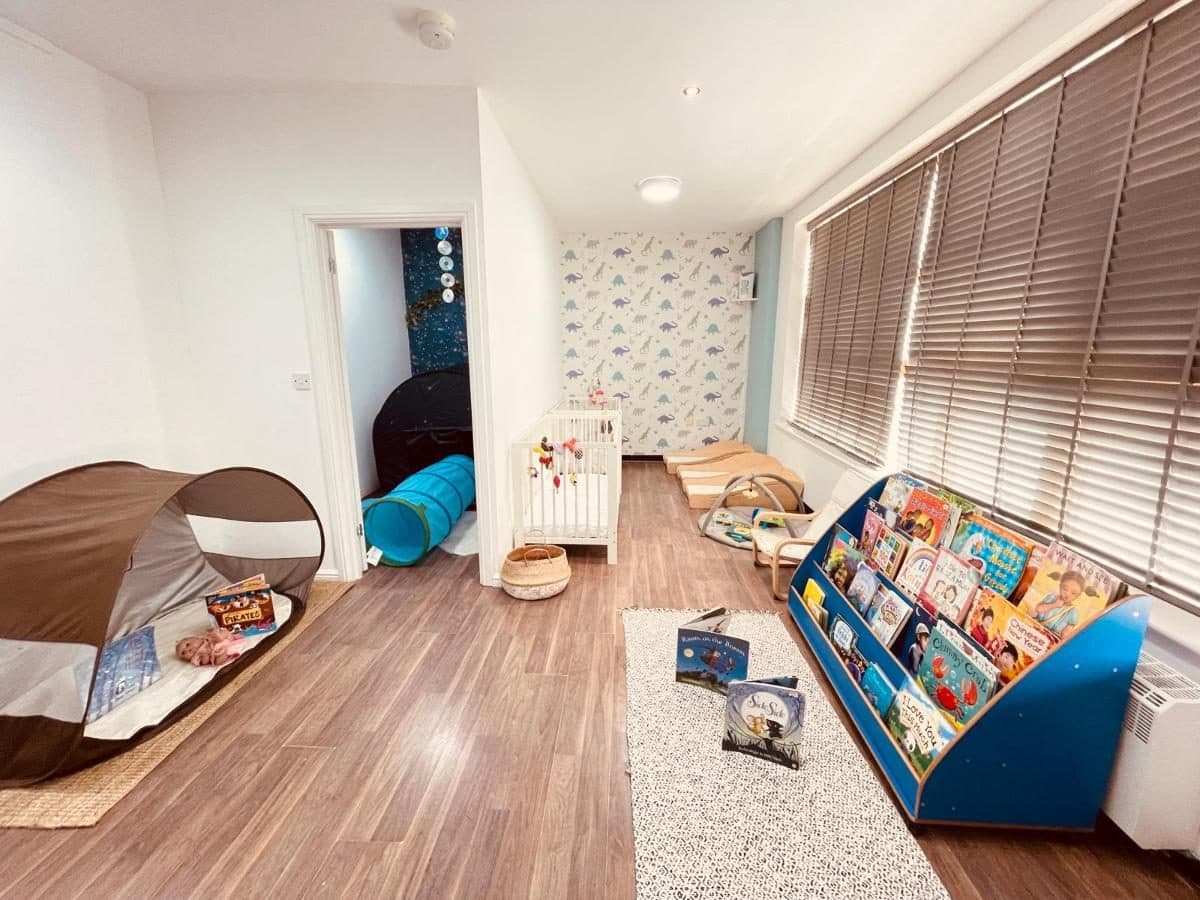 blossoming minds daycare colorful playroom with toys books crib