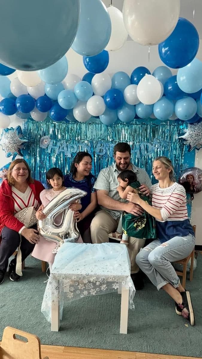 blossoming minds daycare practitioners and children celebrating together