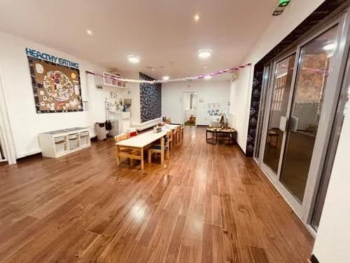 blossoming minds daycare spacious indoor play area with tables